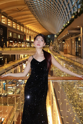 a lady in a black sequin velvet dress